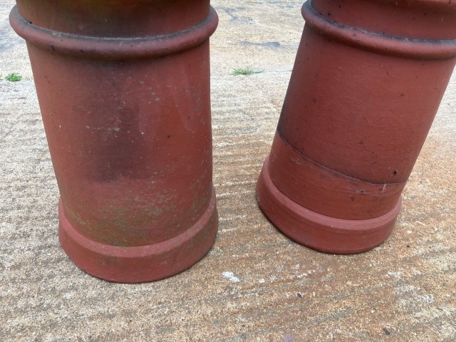 A pair of terracotta louvered chimney pots