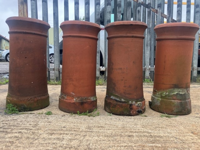 A set of four terracotta chimney pots
